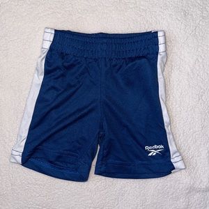 Blue REEBOK shorts with white side strip 12m